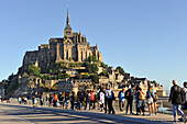 Tourists walking on the new footbridge towards the Mont-Saint-Michel, UNESCO World Heritage Site, Manche department, Normandy region, France, Europe