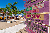 View of restaurant signs and harbour in Thassos Town, Thassos, Aegean Sea, Greek Islands, Greece, Europe