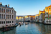 Colorful houses and Camerlenghi Palace seen from the other side of the Grand Canal with traditional gondola boats at sunset, Venice, UNESCO World Heritage Site, Veneto, Italy, Europe