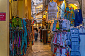 View of shops in old Corfu Town at dusk, Corfu, Ionian Sea, Greek Islands, Greece, Europe