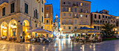 View of buildings and restaurants on Kofineta Square at dusk, Corfu Old Town, UNESCO World Heritage Site, Corfu, The Ionian Islands, Greek Islands, Greece, Europe