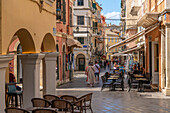 View of shops and cafes in narrow street, Corfu Town, Corfu, Ionian Sea, Greek Islands, Greece, Europe