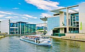 A tour boat on the River Spree passing the Library of the German Parliament on the right near the Reichstag building, Berlin, Germany, Europe