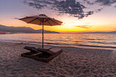 View of sun lounger on the beach and Aegean Sea after sunset, Thassos Town, Thassos, Aegean Sea, Greek Islands, Greece, Europe