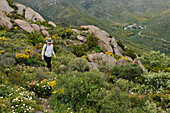 Young woman walking around hamlet in La Vall de Santa Creu, Cap de Creus Natural Park, Costa Brava, Catalonia, Spain, Europe