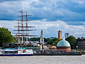 View over River Thames towards Cutty Sark British Clipper Ship and St. Alfege Church in Greenwich, London, England, United Kingdom, Europe