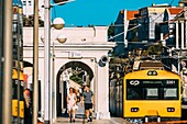 A man and women walk along the platform at Estoril train station in the outskirts of Lisbon, Portugal, Europe