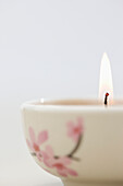 Close up of a burning pink tea light