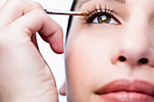 Extreme close up of a woman applying eyeshadow