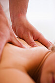 Close up of a masseur hands giving a woman a massage