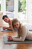 Man and woman practicing yoga