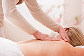 Profile of a woman lying on stomach receiving a massage