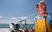 Close up of a fisherman driving a boat