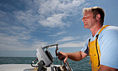 Close up of a fisherman driving a boat