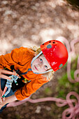 Young girl dangling from a rope - high angle