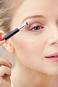 Close-up View of Woman Applying Eye Shadow