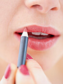 Close-up View of Woman Using Lip Pencil