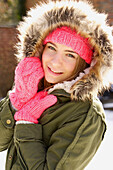 Smiling Teenage Girl Wearing Hooded Parka Outdoors