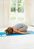 Woman Practicing Yoga in the Child's Pose