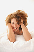 Smiling Woman lying on Bed