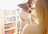 Back View of Woman Holding Dog