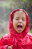 Young Girl with Tongue Sticking Out in the Rain