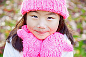 Close up Portrait of Young Girl Wearing Pink Hat and Gloves