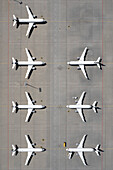 View from above airplanes parked on sunny airport tarmac