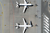 View from above airplanes parked on sunny airport tarmac