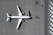 View from above airplane and boarding stairs on sunny airport tarmac