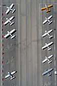 View from above biplanes parked in rows on airport tarmac