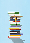 Woman climbing large stack of books