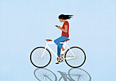 Woman with smart phone text while riding bicycle on blue background