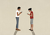 Distracted couple texting with smart phones on beige background