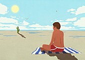 Sunburned man sitting on towel watching cactus on hot summer beach