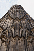 Low angle view dramatic Cologne Cathedral facade, Cologne, Germany