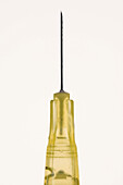 Close up yellow syringe on white background