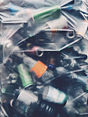 Full frame close up plastic bottles and aluminum cans in recycling bag