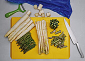 Still life flat lay white and green asparagus on cutting board