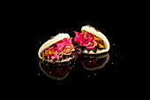 Exquisite Asian bao buns with colourful fillings on black