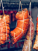 Hanging sobrasada sausages in a traditional curing room