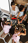 Family baking biscuits together in the kitchen