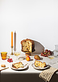 Elegant Italian panettone display with fruit and wine