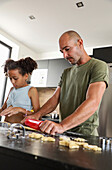 Father and daughter cooking together in a modern kitchen