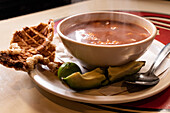 Authentic Mexican tortilla soup with roasted pork and avocado
