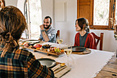 Friends enjoying a meal with a private chef at home