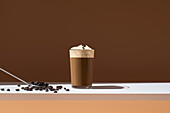 Iced coffee with vanilla ice cream in front of a modern background