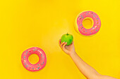 Favouring health over sweet temptation on a yellow background