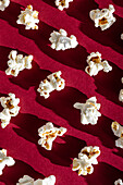 Nostalgic movie night popcorn pattern on a red background