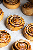 Freshly baked cinnamon rolls on parchment paper